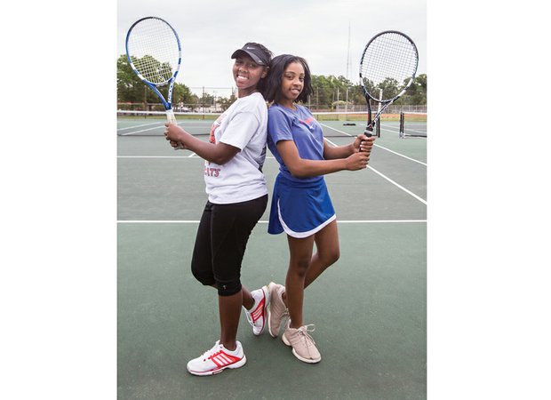 Armstrong High School tennis standouts Sharvae Ward, left, and Jazmine Davis are playing conference matches this week, where Davis has been undefeated the last two years.