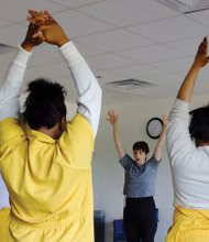 Women participate in a yoga class at the Richmond Justice Center taught by Ellie Burke.