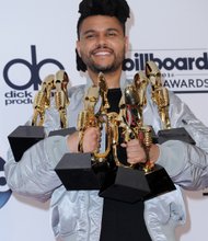 The Weeknd clutches the eight awards he received Sunday during the ceremony. His awards: Top 100 Hot Artist, Top 100 Sales Artist, Top Radio Songs Artist, Top Streaming Songs Artist, Top R&B Artist, Top R&B Album, Top Streaming Song (audio) and Top R&B Song.
