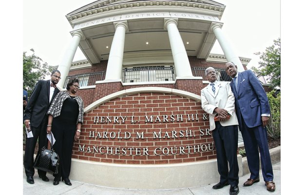 From left, Harold M. Marsh Jr. and Dr. Erica Marsh, the children of Harold M. Marsh Sr.; Henry L. Marsh III; and Richmond Mayor Dwight C. Jones stand in front of the new sign outside the courthouse at 920 Hull St. The South Richmond courthouse was renamed last Friday in honor of Mr. Marsh and his brother, Harold M. Marsh Sr., who died in 1997. 