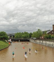 Kayakers and stand-up paddle boarders move along the placid Downtown canal.