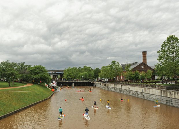 Kayakers and stand-up paddle boarders move along the placid Downtown canal.