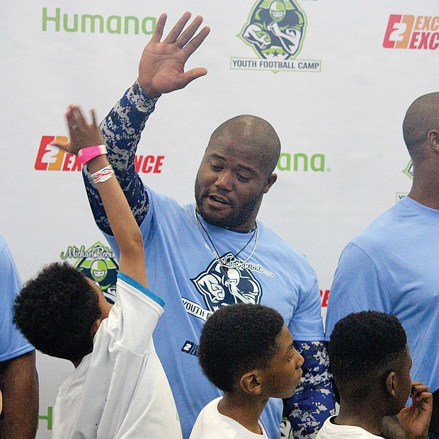 The future of the game // Former Seattle Seahawks fullback and Richmond native Michael Robinson returned home last weekend to host his annual football camp for football enthusiasts ages 8 to 16.
Scores of youngsters turned out for the event at Sports Reality Performance in Mechanicsville to learn tips from the pro himself, left, and several of his notable NFL friends who also worked with the youngsters.