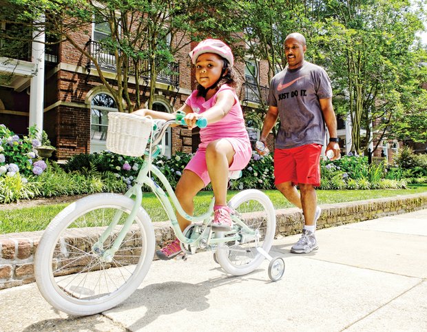 Cruising // Under the watchful eye of her father, Tommy Davis, young Luci cruises on her bicycle along the 500 block of South Davis Avenue during a sunny spell on Memorial Day weekend in the West End. Please see additional holiday photos, Page B3. 

