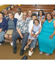 Dr. Roscoe D. Cooper Jr. and his wife, Christa W. Cooper, center, are surrounded by family for his combined birthday-ministerial anniversary celebration that kicked off last Sunday at Metropolitan African American Baptist Church in South Side.