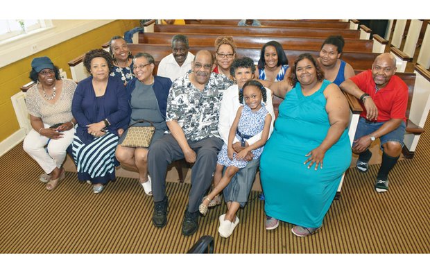 Dr. Roscoe D. Cooper Jr. and his wife, Christa W. Cooper, center, are surrounded by family for his combined birthday-ministerial anniversary celebration that kicked off last Sunday at Metropolitan African American Baptist Church in South Side.