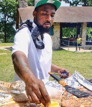 Jerome Ruffin prepares burgers last Saturday for his family’s annual Memorial Weekend cookout in Byrd Park. Above, Larry Smith shows off his catch at Chapel Island Park in the East End. 