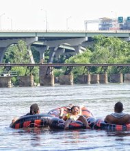 Lynnara Brice, 7, relaxes on the James River last Saturday with her family, from left, Rich Green, Sandra Gebhardt and Alexander Brice.