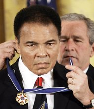 President George W. Bush awards the Medal of Freedom to Mr. Ali at a White House ceremony in November 2005. 