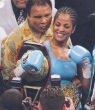 Mr. Ali proudly stands with daughter, boxing champion Laila Ali, after she won the Super Middleweight title in June 2005 at a match in Washington. 