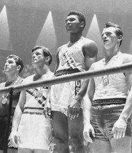 Muhammad Ali, then known as Cassius Clay, stands in the top spot after winning a gold medal in boxing at the 1960 Olympics in Rome.