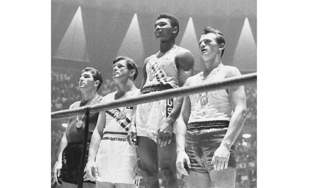 Muhammad Ali, then known as Cassius Clay, stands in the top spot after winning a gold medal in boxing at the 1960 Olympics in Rome.