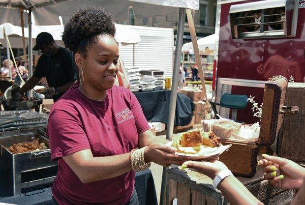 Appetite for Appétit //

Natasha Wilson of Croaker’s Spot serves an eager customer during Sunday’s Broad Appétit, an annual food fest on the main street through Downtown. Hundreds of people enjoyed a variety of dishes from local restaurants during the $3-a-plate smorgasbord spanning four blocks on East Broad Street between Henry and Adams streets. Art, music and vendors also lured festivalgoers to the event hosted by the Downtown Neighborhood Association. Proceeds benefit FeedMore, a Central Virginia hunger-relief organization. 

