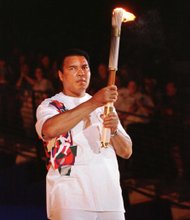 Muhammad Ali holds the Olympic torch as he prepares to light the flame and open the 1996 games in Atlanta.