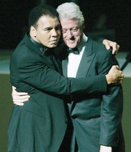 the boxing champ hugs former President Bill Clinton at a gala to open the Muhammad Ali Center in Louisville in November 2005.
