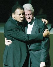 the boxing champ hugs former President Bill Clinton at a gala to open the Muhammad Ali Center in Louisville in November 2005.