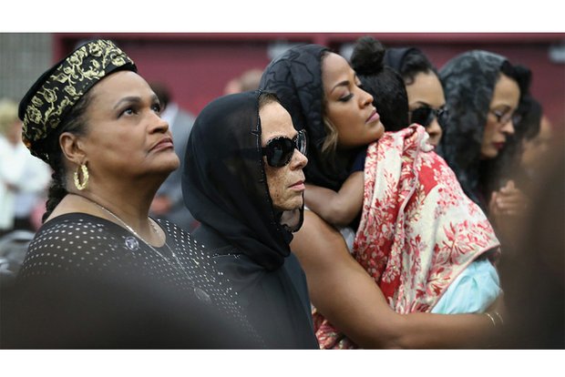 Muhammad Ali’s family takes part in the traditional Muslim service last Thursday at Louisville’s Freedom Hall for The Champ. They are, from left, Khalilah Ali, Mr. Ali’s second wife; Lonnie Ali, his wife of the last 30 years; and daughter Laila Ali.
