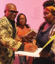 Family Day at VMFA // Artist Kehinde Wiley, left, signs an exhibition catalogue last Friday for Chelsea Burwell as Amber Cole waits for his autograph at the Virginia Museum of Fine Arts, where a ret- rospective of Mr. Wiley’s work opened during the weekend. Enthusiasm for the exhibit, “Kehinde Wiley: A New Republic,” drew thousands of Richmond area residents to the museum’s free Family Day festivities last Saturday, where people of all ages enjoyed a variety of music, art and activities throughout the museum and its grounds.