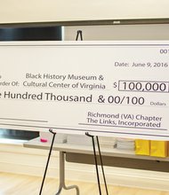 Links to history // Dr. Jill Bussey Harris, second from right, president of the Richmond Chapter of The Links Inc., presents a $100,000 check to officials from the Black History Museum & Cultural Center of Virginia. Accepting the donation, to be made by the women’s service organization over five years, are, from left, museum director Tasha Chambers; Dr. Monroe Harris, chairman of the museum’s campaign fund and husband of Dr. Bussey Harris; and Marilyn H. West, chair of the museum’s board. The presentation took place June 9 at the museum, where the chapter held its year-end celebration hosting a dinner for 15 girls at Franklin Military Academy involved in the chapter’s Focused Motivated Achievers program. In its third year, the program seeks to follow the eighth-graders through high school. 
