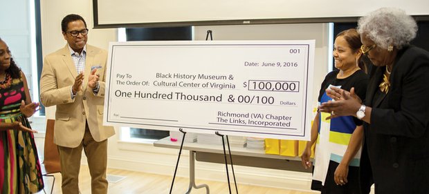 Links to history // Dr. Jill Bussey Harris, second from right, president of the Richmond Chapter of The Links Inc., presents a $100,000 check to officials from the Black History Museum & Cultural Center of Virginia. Accepting the donation, to be made by the women’s service organization over five years, are, from left, museum director Tasha Chambers; Dr. Monroe Harris, chairman of the museum’s campaign fund and husband of Dr. Bussey Harris; and Marilyn H. West, chair of the museum’s board. The presentation took place June 9 at the museum, where the chapter held its year-end celebration hosting a dinner for 15 girls at Franklin Military Academy involved in the chapter’s Focused Motivated Achievers program. In its third year, the program seeks to follow the eighth-graders through high school. 
