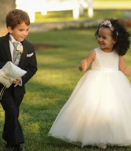 Below, Mr. Morrissey’s daughter, Kennedy, 3, shares a laugh as she starts her duties as flower girl with his 7-year-old nephew, John, the ring bearer.