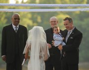 The couple’s son, 15-month-old Chase, was held during the ceremony by his father.
