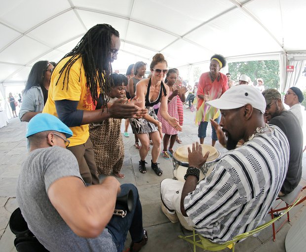 Family Day at VMFA//Dancers enjoyed the beats of the Afro Beta Drummers under a tent outside, while a member of the Harlem Chamber Players, right, entertained the crowd