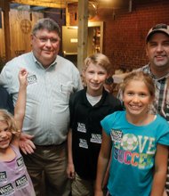 Republican Michael L. “Mike” Wade, second from left, is joined by his smiling family after Tuesday’s primary win over Jackee K. Gonzalez. With him are, from left, granddaughter Charlotte, wife JoAnn, grandson Michael, granddaughter Betsy, son-in-law Carey Wood and daughter Jessica Wood.