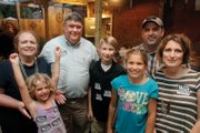 Republican Michael L. “Mike” Wade, second from left, is joined by his smiling family after Tuesday’s primary win over Jackee K. Gonzalez. With him are, from left, granddaughter Charlotte, wife JoAnn, grandson Michael, granddaughter Betsy, son-in-law Carey Wood and daughter Jessica Wood.