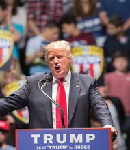 Donald J. Trump, the presumptive Republican Party nominee for president, addresses a half-full Richmond Coliseum crowd last Friday during a campaign swing through the battleground state.