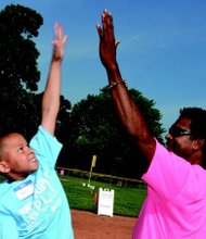 Triple Play in action: A Boys & Girls Counselor congratulates a young member on his home run. (Photo courtesy of Boys & Girls Club of America)