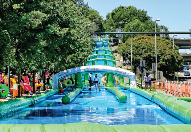  Big fun on the big slide on Byrd  // Byrd Street in Downtown was turned into a giant water slide Saturday with Slide the City, a 1,000 feet of fun that drew long lines of bathing suit-clad people ready to enjoy the summer.