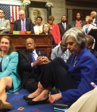 Rep. Katherine Clark of Massachusetts tweeted a photo from the floor of the U.S. House of Representatives on Wednesday showing the sit-in demanding common sense gun control legislation to keep suspected terrorists from buying guns and tightening background checks. Sitting on the floor in the center is Rep. John Lewis of Georgia, who led the historic action.