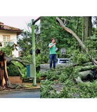 Cityscape //These scenes show examples of the impact of the June 16 storm that hammered Richmond and Henrico County and knocked out power to nearly 120,000 homes and businesses in the two localities. Left, Laurie Petersen photographs a tree split during the raging winds at Monument and Roseneath avenues in the West End. Right, Brad Spangler takes a closer look at a car crushed under trees felled by the storm that packed 70 mph winds and dropped 1.6 inches of rain. Location: Seminary and Claremont avenues in North Side. Richmond area damage estimates ranged from $2 million to $5 million, including $770,000 in damage to 10 Richmond school buildings. Officials said all but $100,000 of the schools damage would be covered by insurance. Dominion brought in hundreds of workers, who helped restore power by late Monday. Fifty crews from the City of Richmond, meanwhile, cleared fallen trees blocking 156 streets and removed 700 tons of tree debris through Tuesday. As of Tuesday night, Byrd Park, Battery Park Pool and Bryan Park had yet to reopen. The city and Henrico County are offering to haul away tree limbs from residents’ property. In the city, residents can place limbs and brush near the curb or alley for pickup. County residents must register for service at (804) 501-4275 or online at www.henrico.us/services/storm-debris-pickup. The county’s deadline to sign up is Friday, June 24.     
