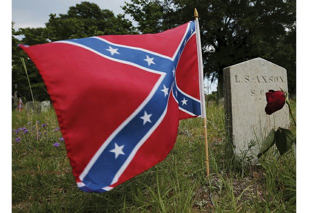 A Confederate battle flag flies at the grave of L.S. Axson, a Confederate soldier buried in Magnolia Cemetery in Charleston, S.C.