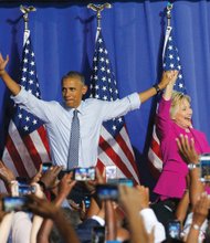 President Barack Obama waves with Hillary Clinton, the presumptive Democratic presidential nominee, at a campaign event Tuesday in Charlotte, N.C. Neither the president or Mrs. Clinton were told ahead of time about the FBI announcement or conclusion.