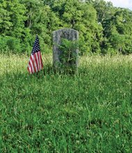 A flag marks a veteran’s grave in private Evergreen Cemetery, located off Nine Mile Road in Eastern Henrico County. The Virginia Outdoors Foundation has launched an effort to preserve and protect the cemetery that dates to 1891.