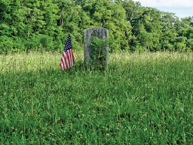 A flag marks a veteran’s grave in private Evergreen Cemetery, located off Nine Mile Road in Eastern Henrico County. The Virginia Outdoors Foundation has launched an effort to preserve and protect the cemetery that dates to 1891.