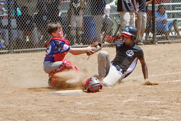 Deon Harns, right, of the Metropolitan Junior Baseball League team slides into base under the glove of Chesterfield Blue Sox catcher Britton Proffitt during the fourth annual Richmond Flying Squirrels Regional Youth Tournament last weekend at Harry G. Daniel Park at Ironbridge. 