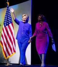 Democratic presidential candidate Hillary Clinton, left, is accompanied by national NAACP board member Hazel Dukes as she arrives to deliver the keynote speech last Monday to thousands of delegates attending the civil rights organization’s 107th annual convention in Cincinnati.