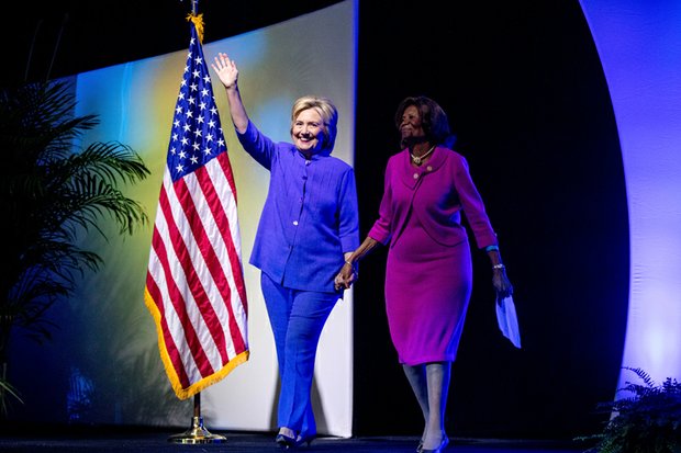 Democratic presidential candidate Hillary Clinton, left, is accompanied by national NAACP board member Hazel Dukes as she arrives to deliver the keynote speech last Monday to thousands of delegates attending the civil rights organization’s 107th annual convention in Cincinnati.