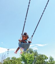 Swing high //
Fahdor Rivers, 6, provides some brotherly love and a
big push for his 2-year-old sister, Zinai Brooks, who gleefully glided back and forth on the toddler swings at the Carter Jones Park on Perry Street in South Side. The youngsters’ mother, Ashley Brooks, was close by with a watchful eye