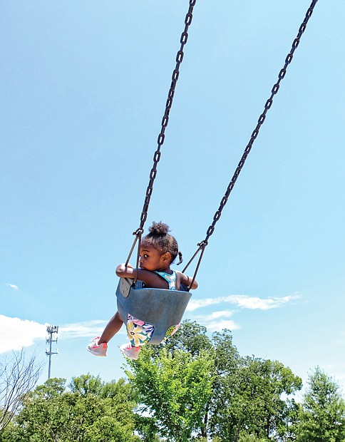 Swing high //
Fahdor Rivers, 6, provides some brotherly love and a
big push for his 2-year-old sister, Zinai Brooks, who gleefully glided back and forth on the toddler swings at the Carter Jones Park on Perry Street in South Side. The youngsters’ mother, Ashley Brooks, was close by with a watchful eye