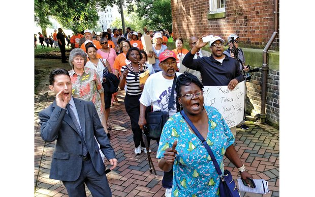 Sandra Sellars/Richmond Free Press
More than 100 people march to the Virginia Supreme Court building following Tuesday’s rally in Capitol Square supporting Gov. Terry McAuliffe’s order restoring voting rights to more than 200,000 felons.