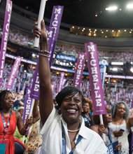 Delegate Cherelle Parker of Pennsylvania, center, cheers First Lady Michelle Obama at the Wells Fargo Center in Philadelphia on the opening day of the Democratic National Convention.