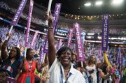 Delegate Cherelle Parker of Pennsylvania, center, cheers First Lady Michelle Obama at the Wells Fargo Center in Philadelphia on the opening day of the Democratic National Convention.