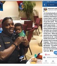 Cpl. Montrell Scott of Baton Rouge, La., shows off his young son in a photo posted on Facebook with the emotional message expressing his concern and frustration about police and African-Americans written just a week before he was shot and killed in a police ambush.