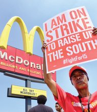 Walkout for living wage // Rolanda McMillan protests pay and working conditions in front of the McDonald’s restaurant at 2011 Chamberlayne Ave. She was among 28 workers at the restaurant who picketed last Thursday for basic safety equipment such as oven mitts and to protest cuts to work schedules. 