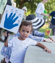 One of God’s children //
Gabriel Denison, 2, holds a sign offering details of his ethnic background during last Friday’s Three Parks Walk for Peace in the East End. The youngster attended the march with his parents, Liz and Rob Denison, and year-old sister, Cora, as people gathered with messages of hope and unity despite the recent violence in U.S. communities and abroad. Please see story, more photos, B2.