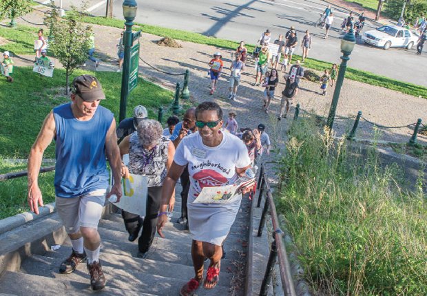 A string of walkers climb the stairs to Jefferson Park, the final stop on the Three Parks Walk for Peace last Friday sponsored by the Neighborhood Resource Center, Central Montessori School and other community groups.